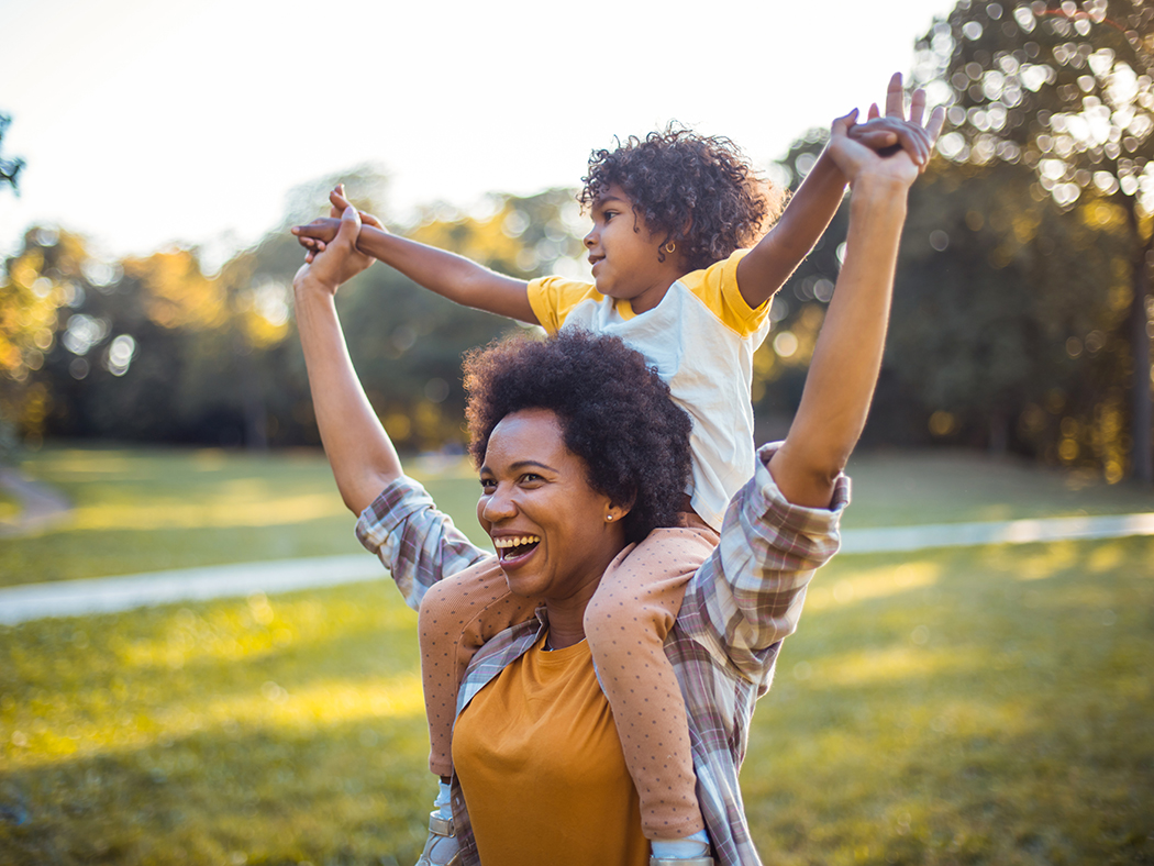 woman with kid on her shoulders