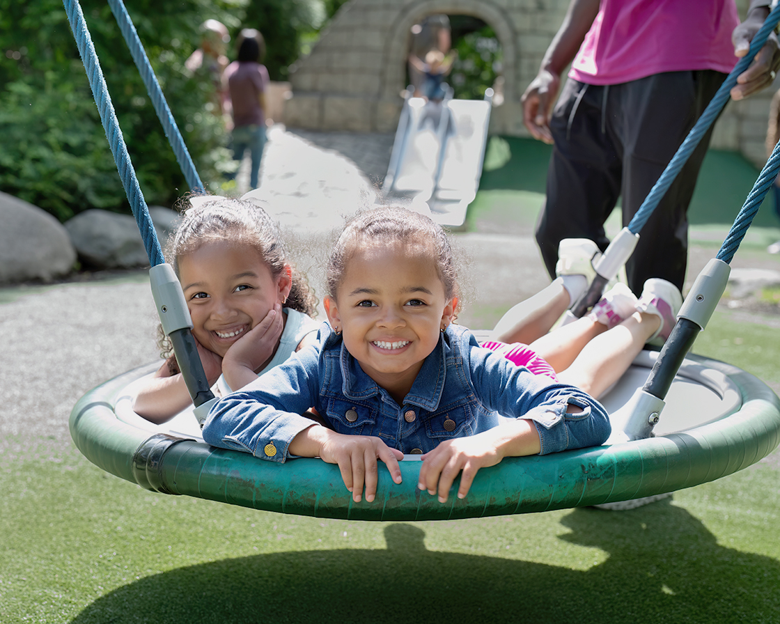 girls playing on a swing