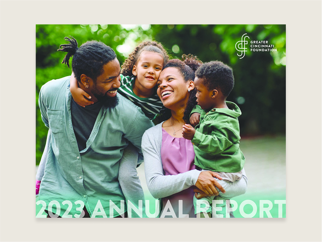 A mother and father holding their two kids with GCF's logo in the top right corner and 2023 annual report at the bottom