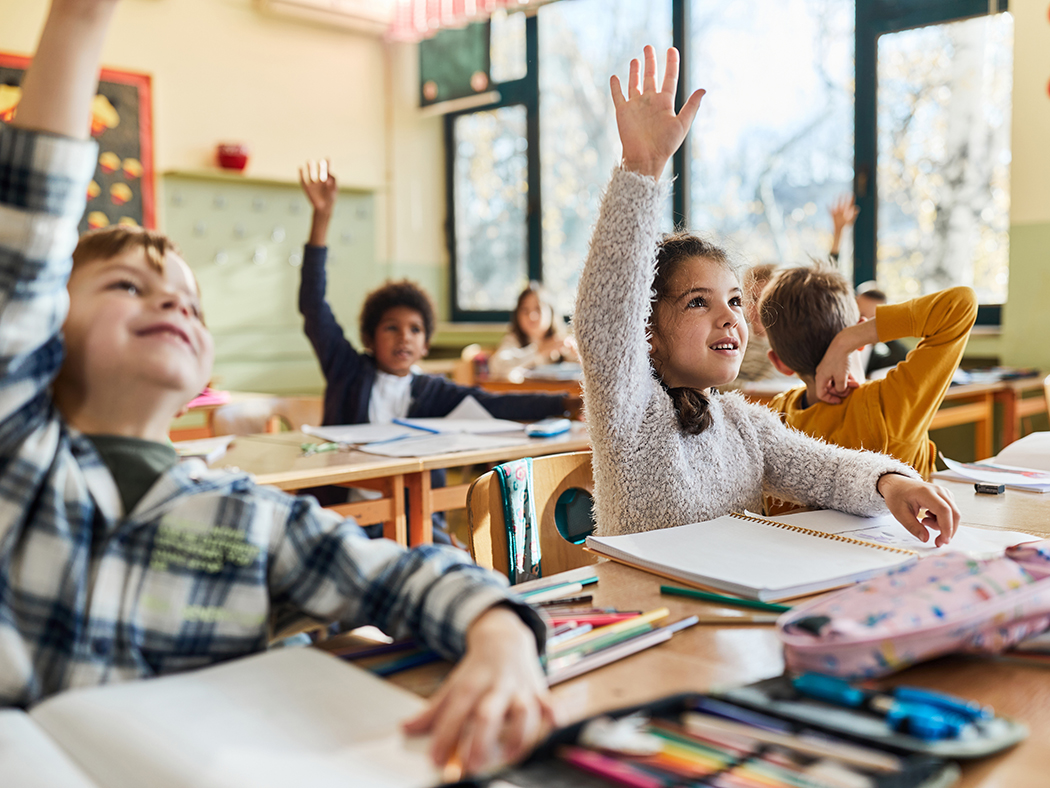 Kids in class raising hands